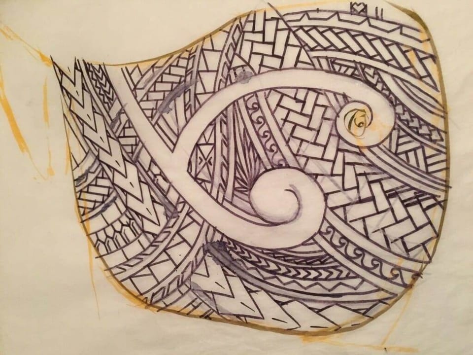 Polynesian spirals and geometric patterns form a tattoo design on tracing paper.