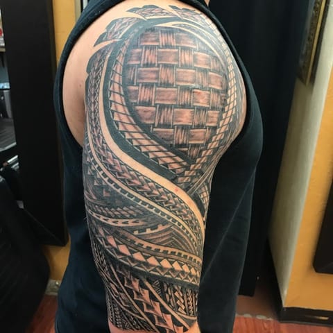 Polynesian shoulder piece with brick-pattern shading, tattooed by Seth Reynolds