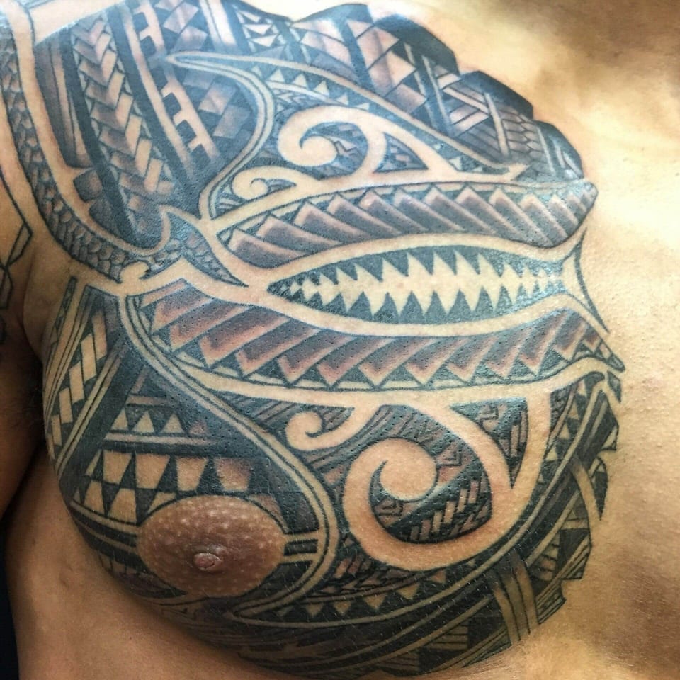 Polynesian tribal pattern across a man's chest and shoulder, tattooed by Seth Reynolds