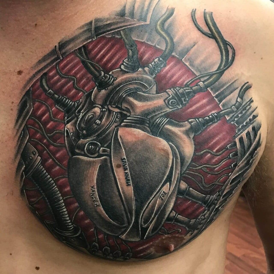 A biomechanical metal heart with cables sits against red shading on the chest.