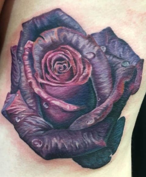 A realistic purple rose with blue shading and water droplets fills the upper arm.