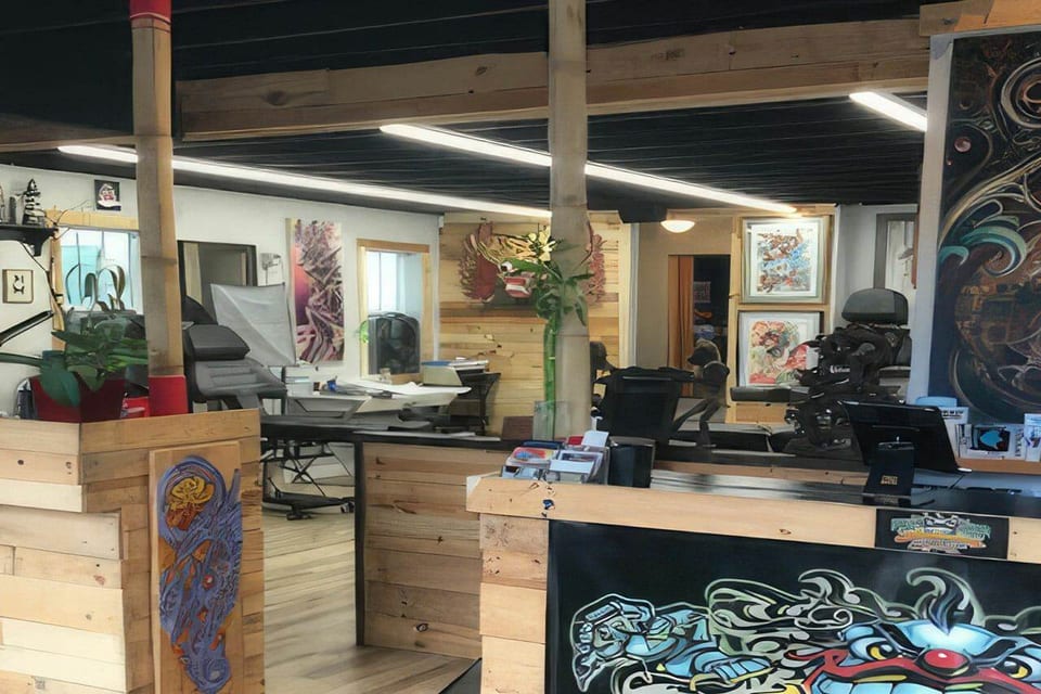 Wooden partitions, tattoo chairs and framed artwork fill the Funhouse Tattoo interior.