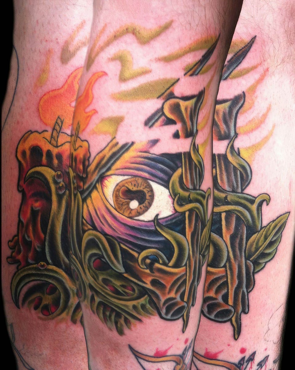 An illustrative colorful eye sits beside a melting candle and curling branches tattooed on a thigh in a collage.