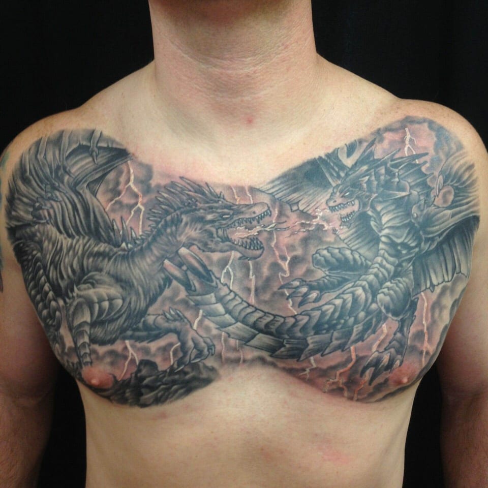 Black and grey winged dragons face each other amid lightning across the chest.
