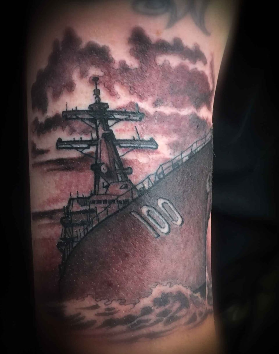 A black and grey realism warship sails beneath clouds on a tightly cropped limb.