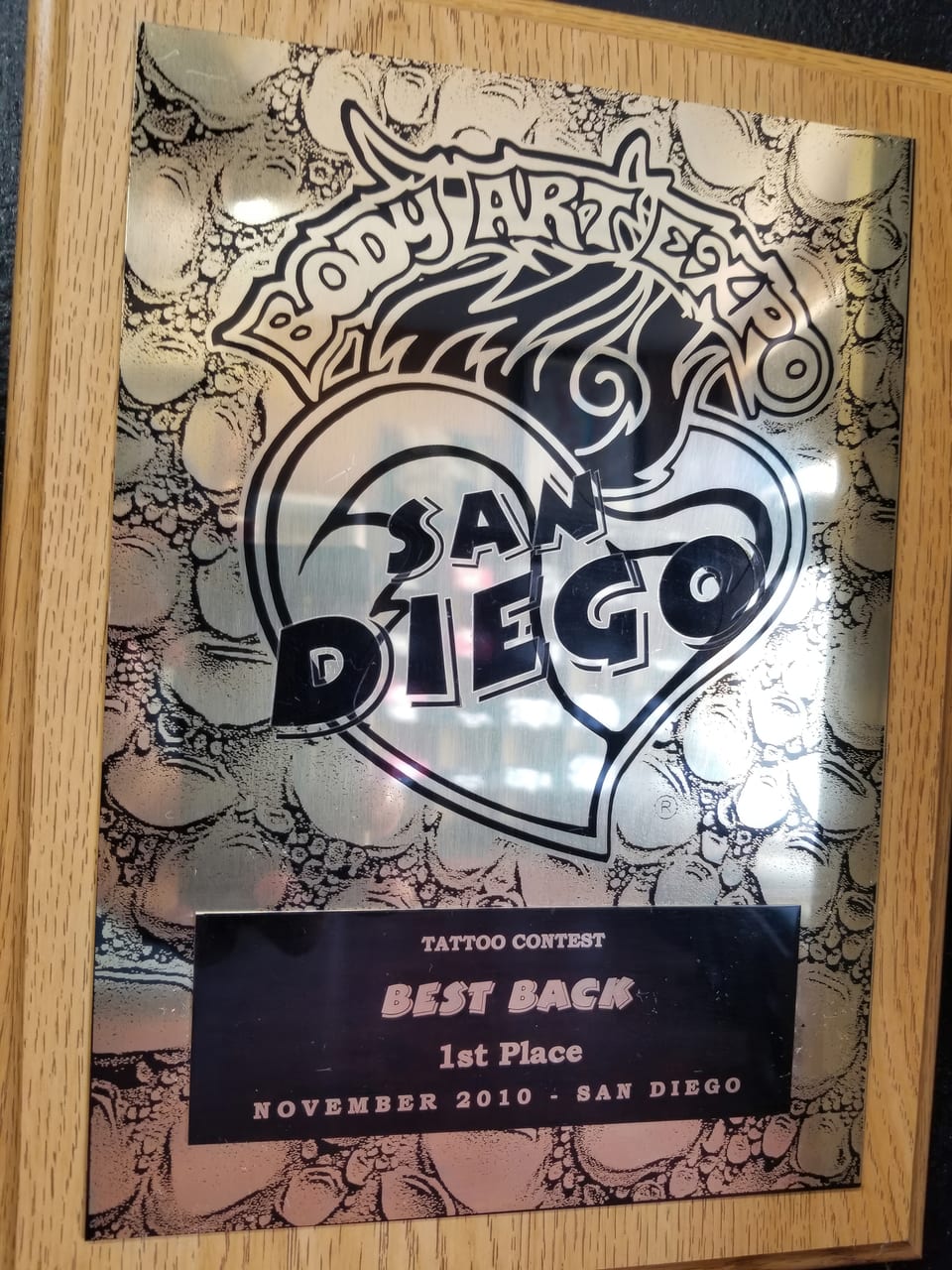 A framed Body Art Expo plaque reads "Best Back" and "First Place."