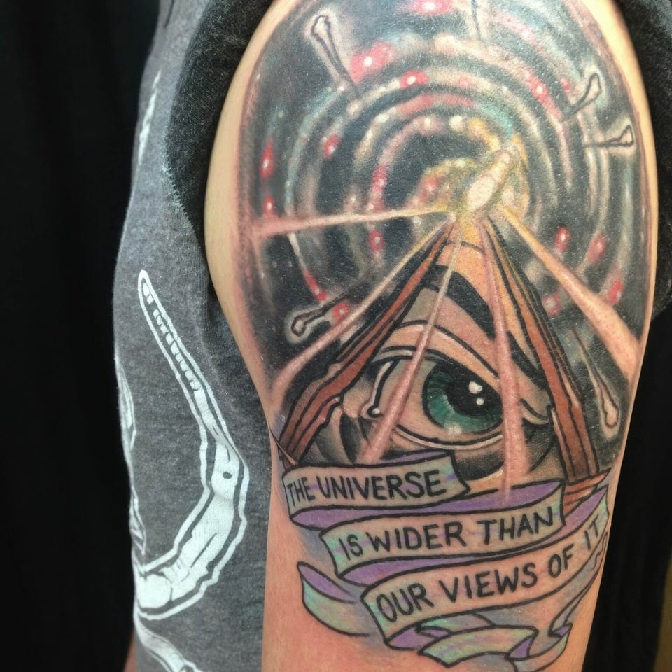 A color illustrative green eye sits in a pyramid beneath a spiral galaxy and lettered banners on the upper arm.