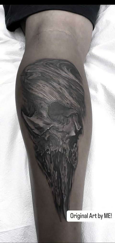 A black and grey illustrative elongated skull with woodlike textures covers a calf.