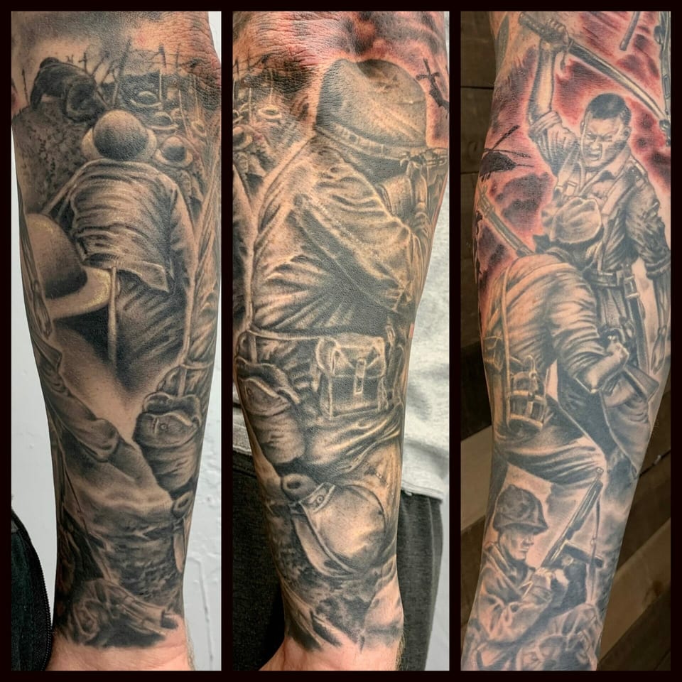 Black and grey realism soldiers in battle cover the arm in several views of a war-themed sleeve.