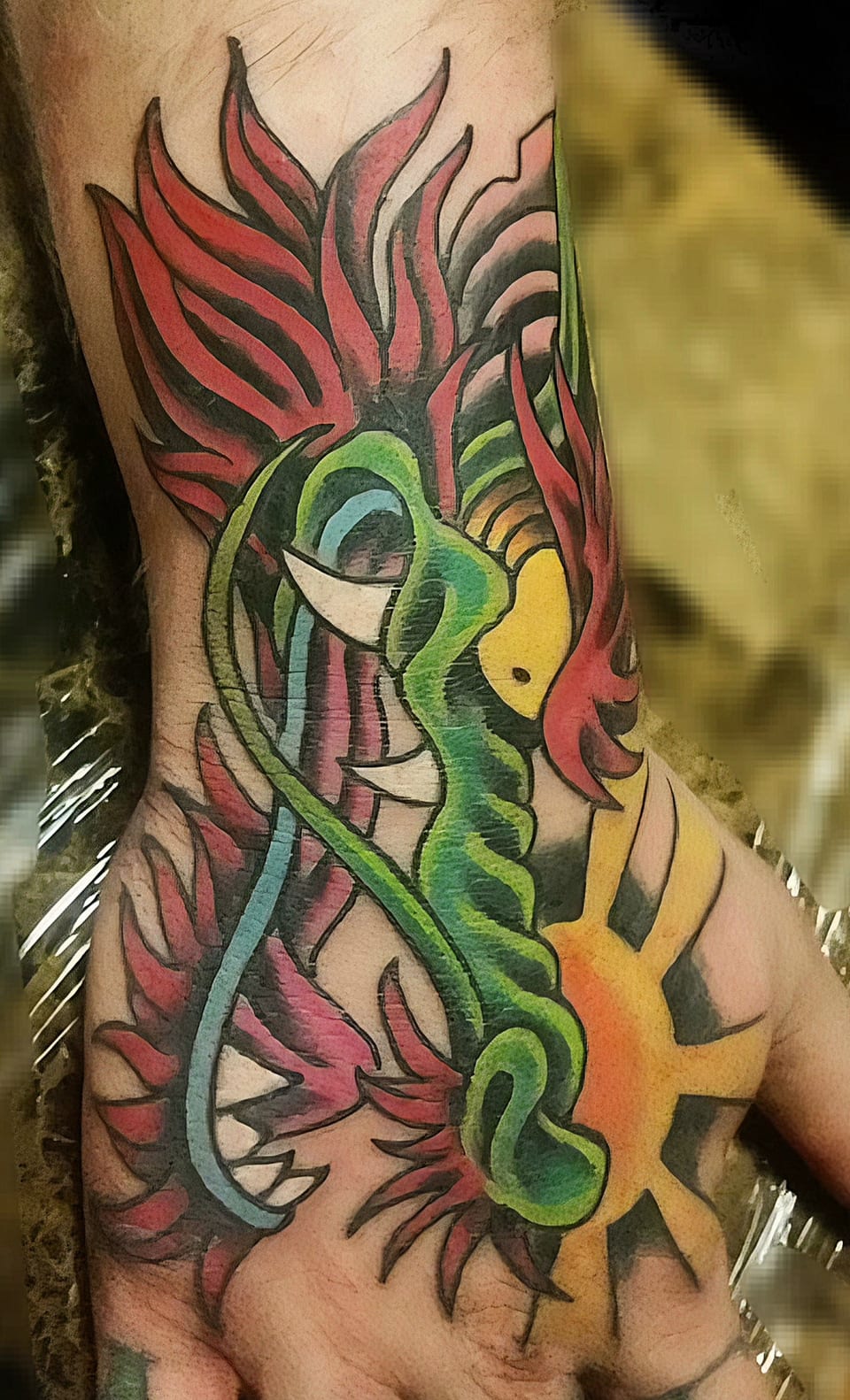 A bright green, red and gold ornamental dragon covers a foot tattoo.