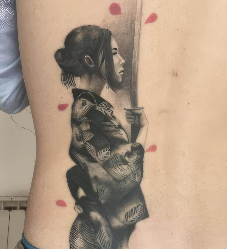 A black and grey realistic woman in a patterned kimono with pink petals extends down the back.