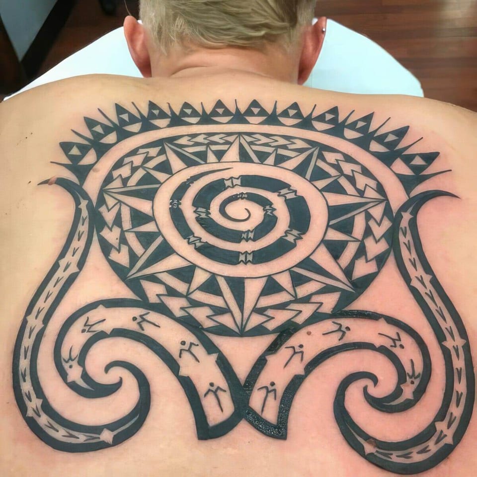 Black Polynesian-style spiral and sun pattern covering an entire back, tattooed by Seth Reynolds