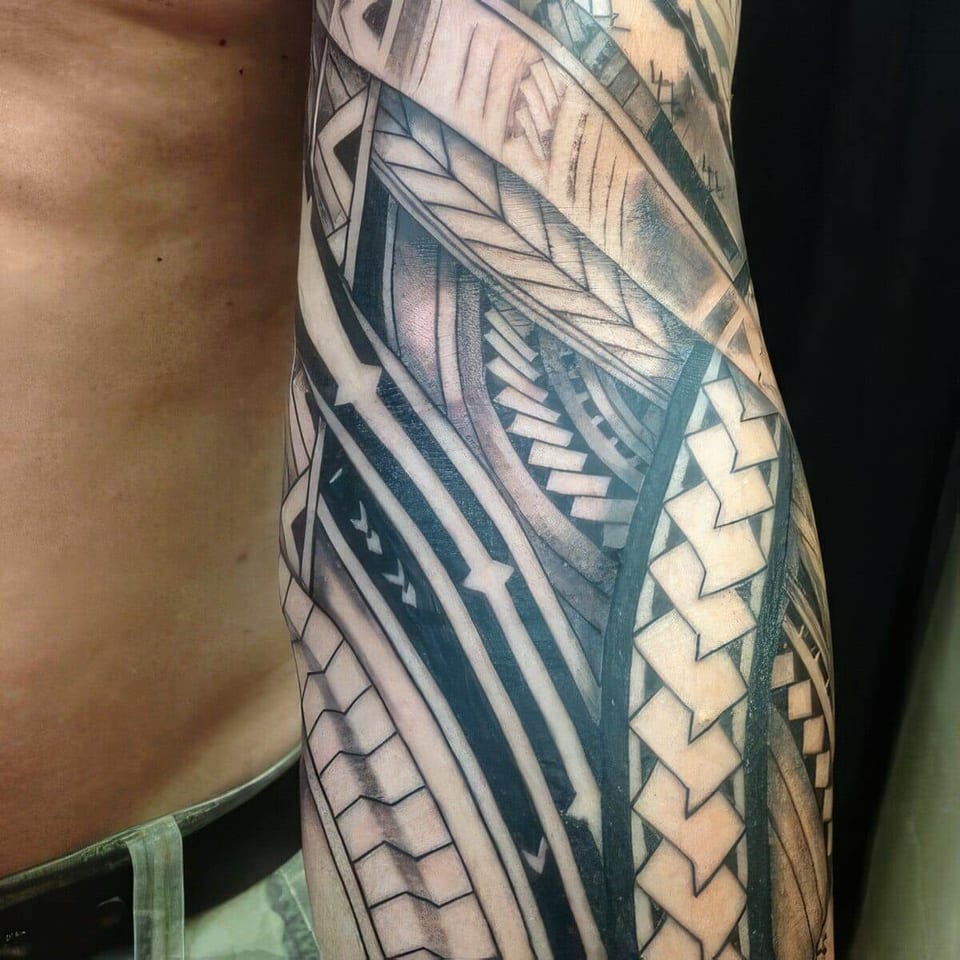Black Polynesian-style woven bands tattooed on a forearm, tattooed by Seth Reynolds