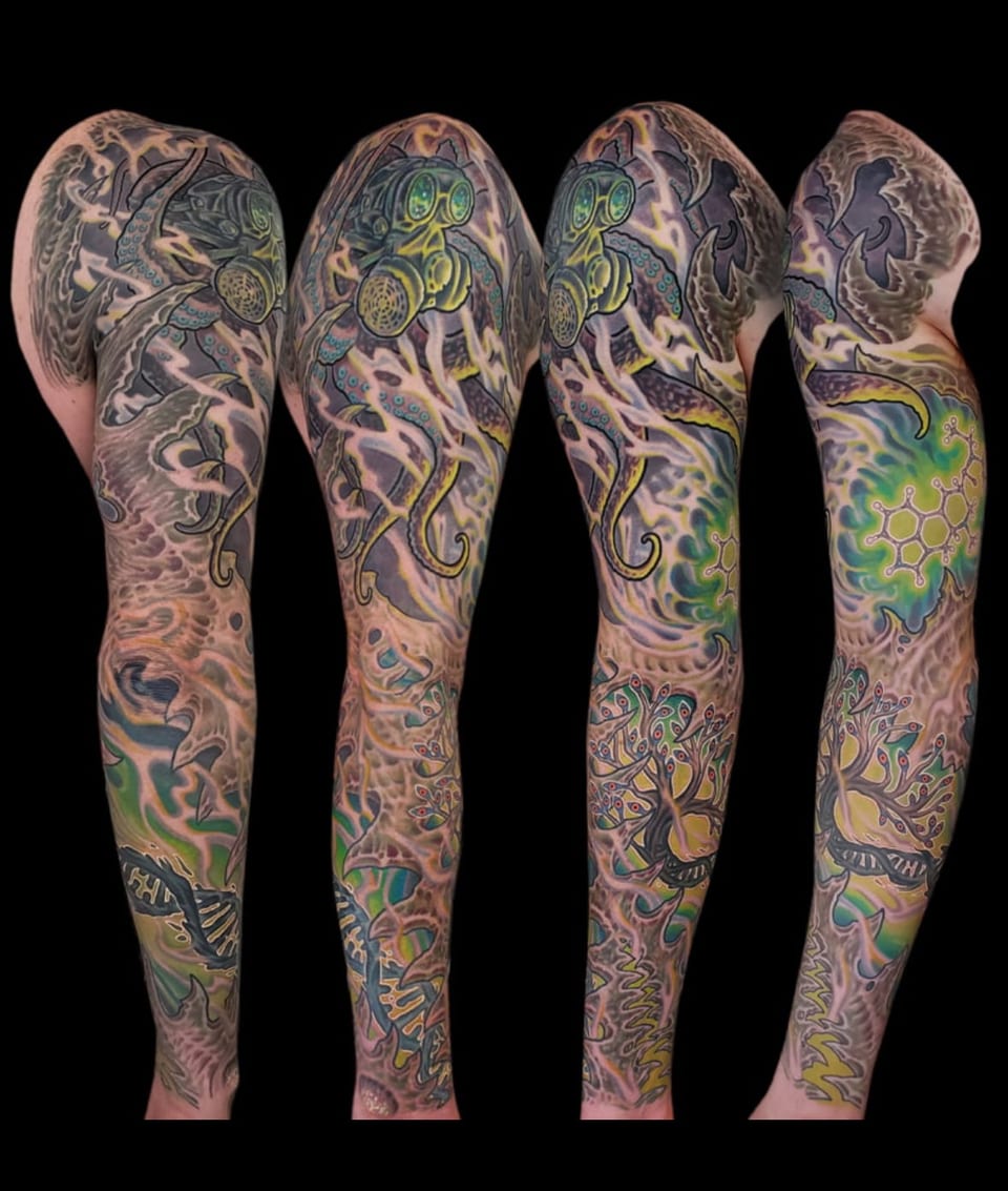 A color bioorganic gas mask, tentacles and abstract shapes cover an arm sleeve shown in a collage.