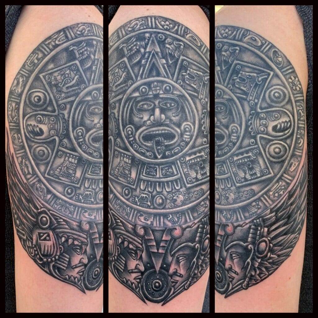 An aztec calendar tattoo on a man's arm.