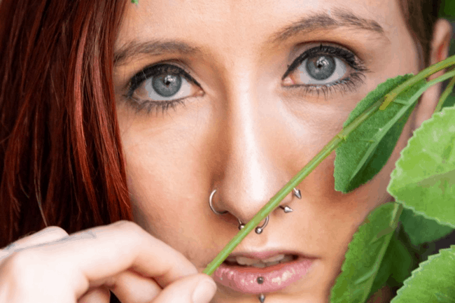 picture of a girl with piercings in her nose and face