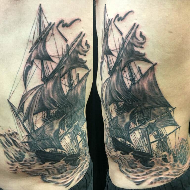 A tattoo of a sailing ship in the ocean.