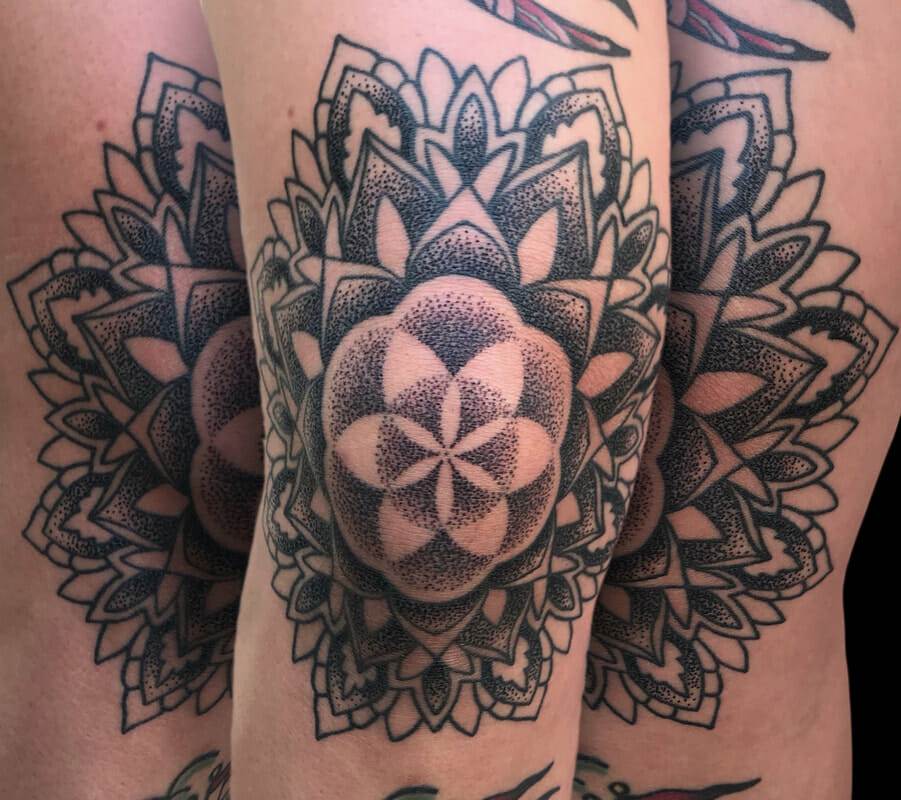 Black and grey mandala tattoo.