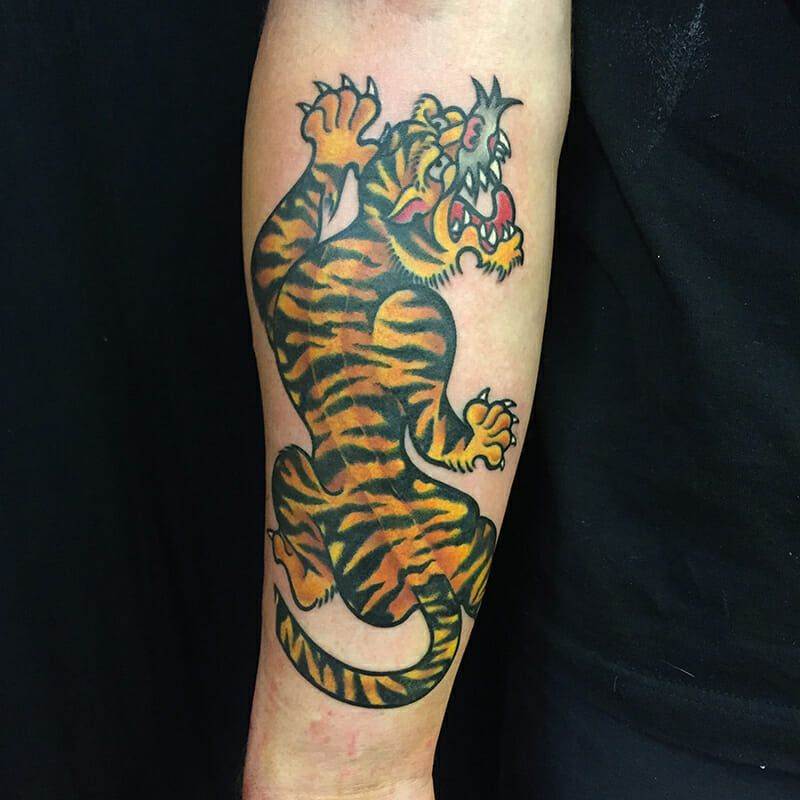 A tattoo of a tiger on the forearm.