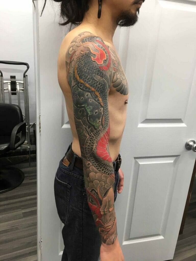 A man with a dragon tattoo on his sleeve.