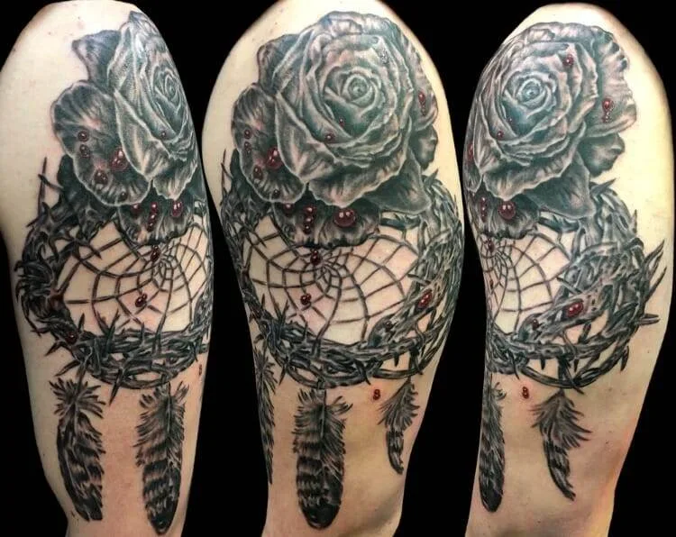 Tattoo design of dream catcher with feathers and roses.