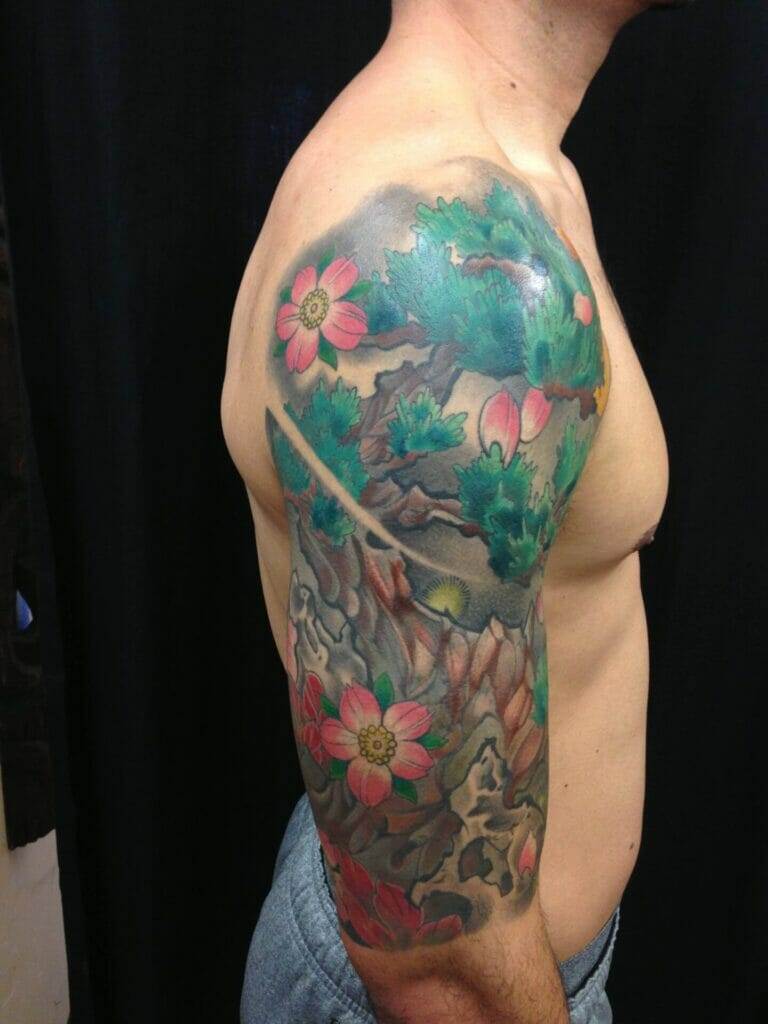 A man adorned with a sleeve tattoo of flowers.