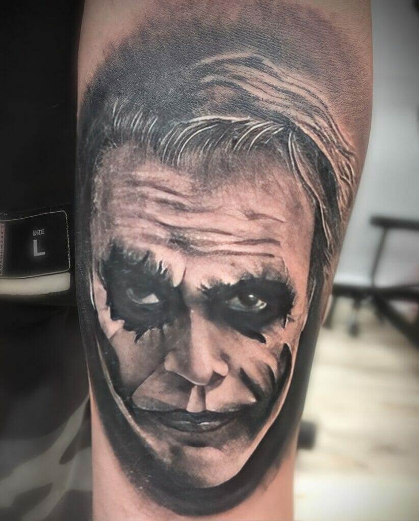 The joker tattoo on a man's forearm.