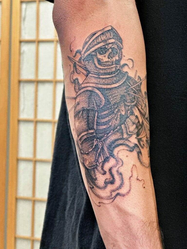 A man with a tattoo of a skeleton on his forearm.