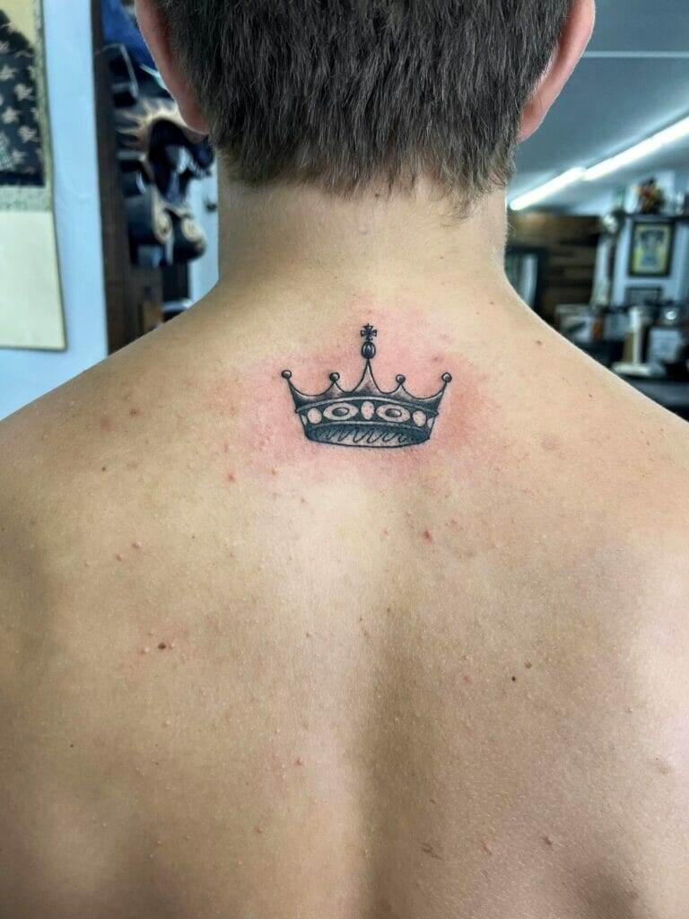 A man with a crown tattoo on his back.