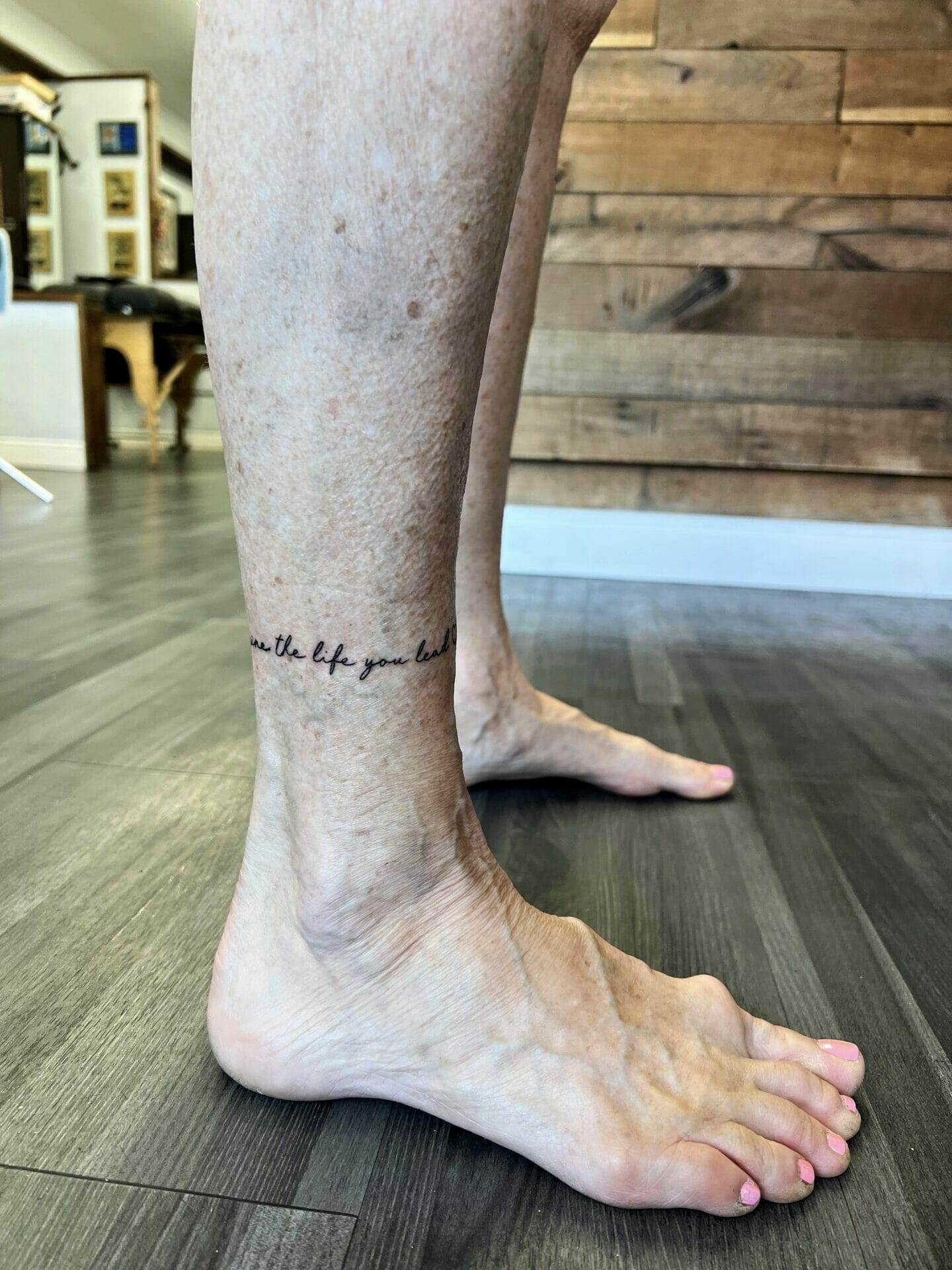 A woman's foot with a tattoo on it.