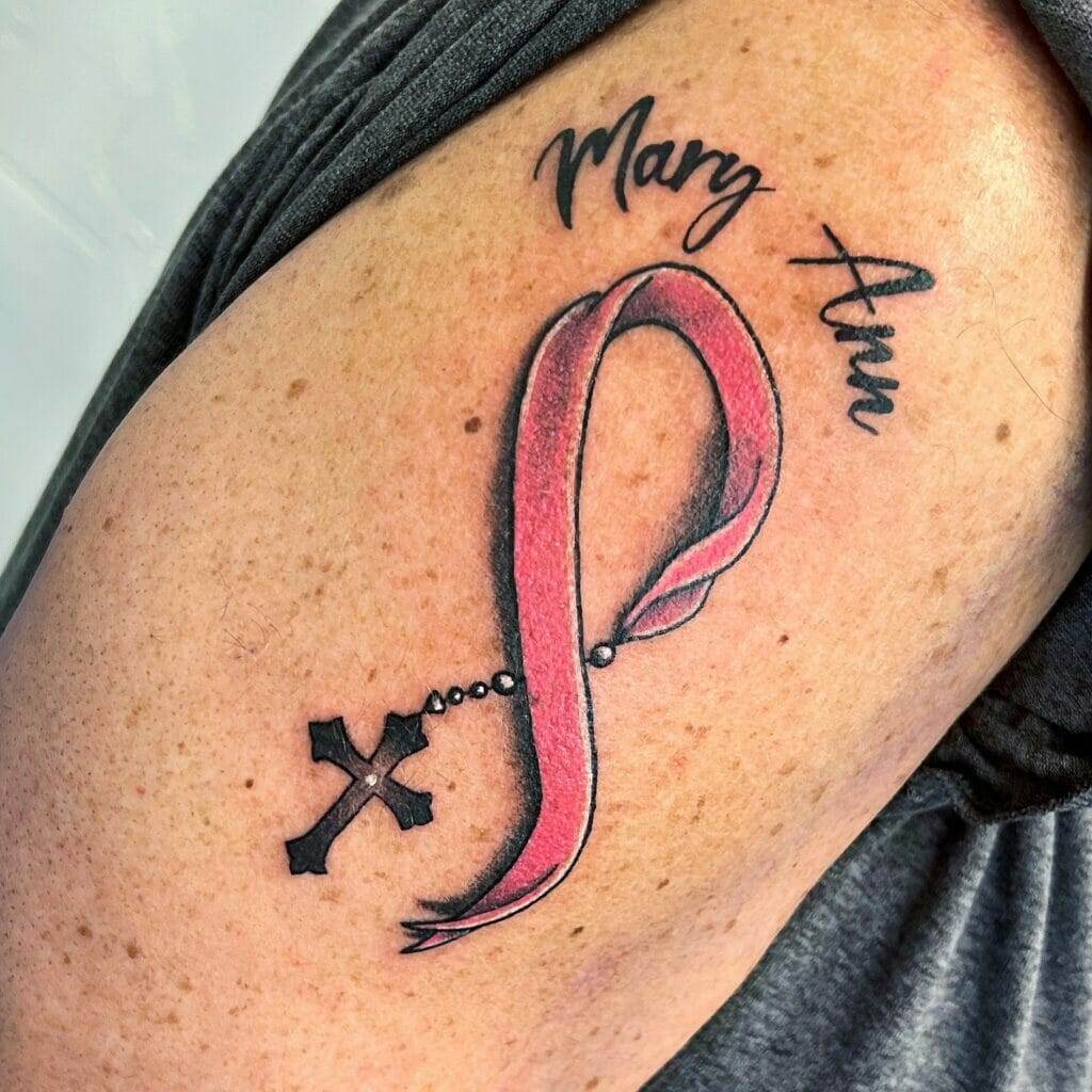 A woman with a pink ribbon tattoo on her arm.