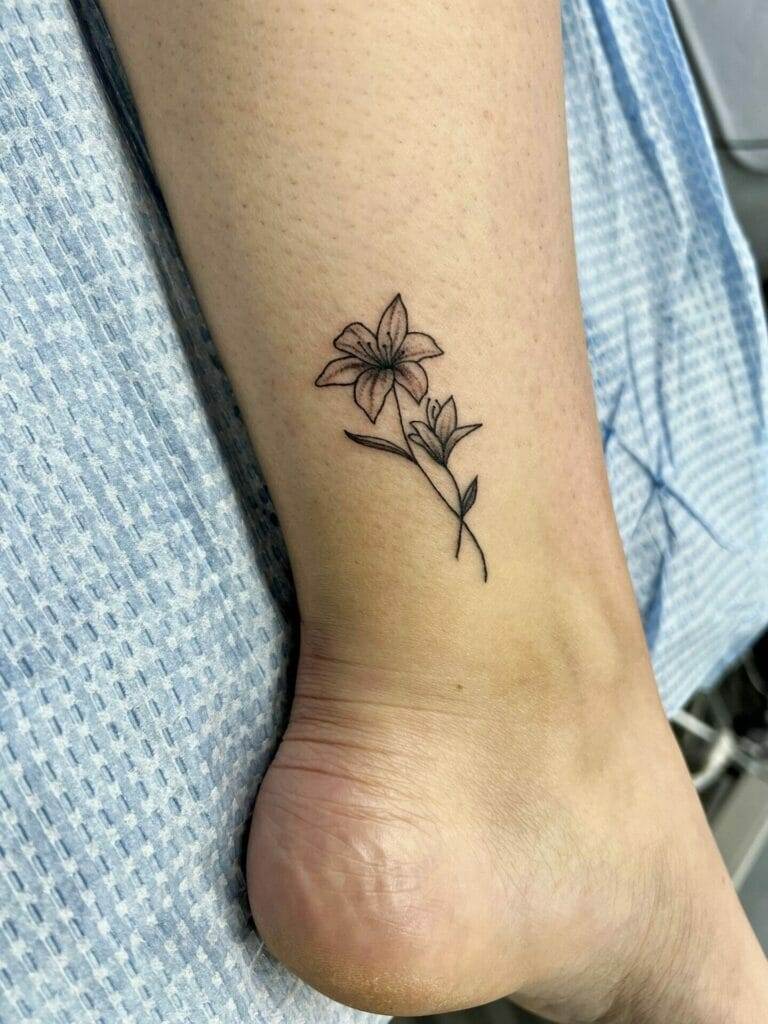 A small flower tattoo on the ankle.