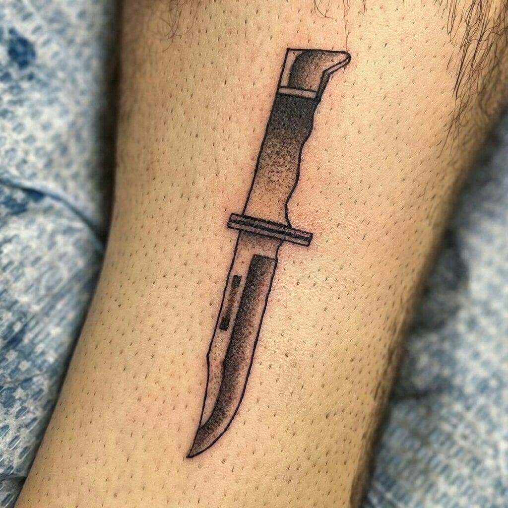 A tattoo of a knife on the ankle.