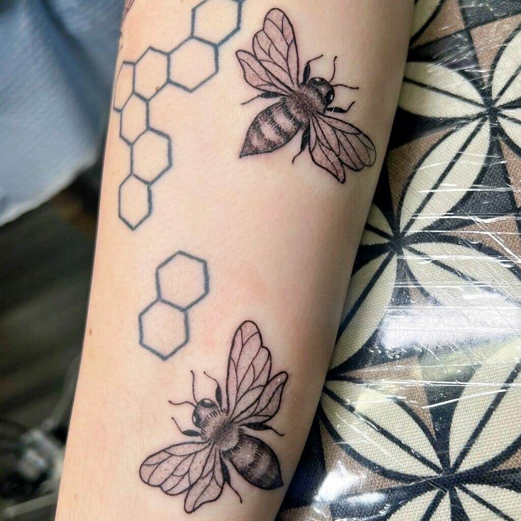 A bee tattoo on a woman's forearm.