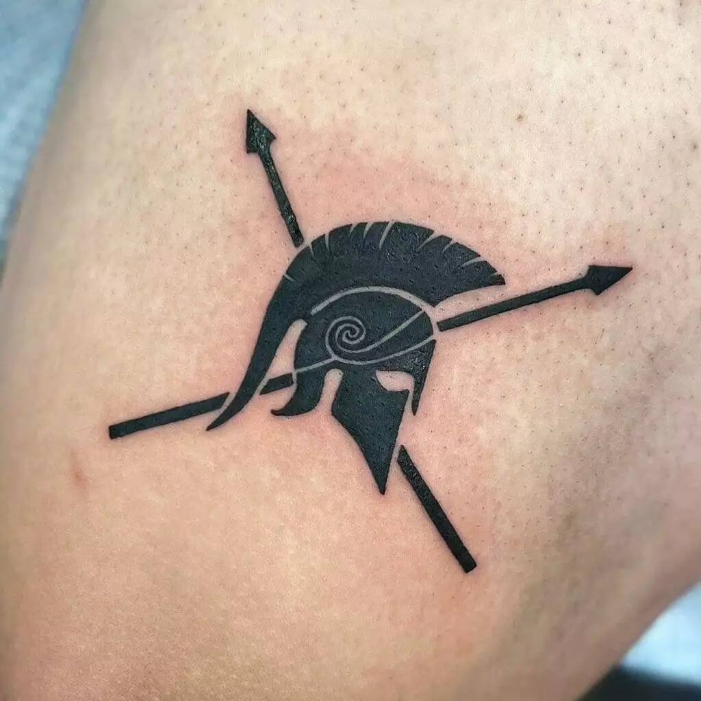 A tattoo of a spartan helmet and arrows.