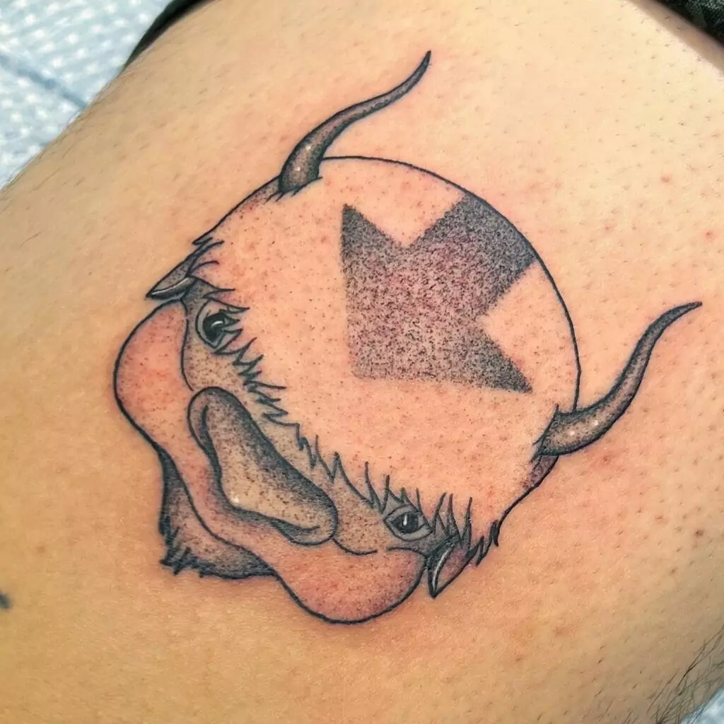A tattoo of a buffalo with an arrow on it.