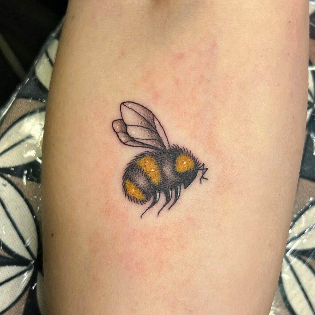 A bee tattoo on a woman's thigh.