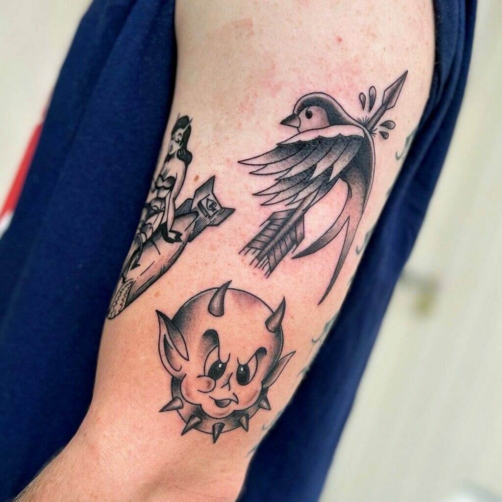 A man with a tattoo of a bird and a devil on his arm.