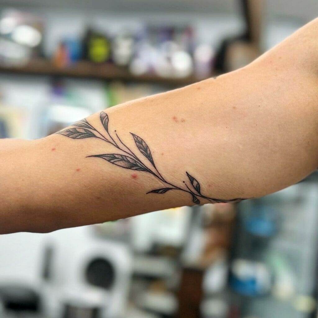 Minimalistic line tattoo located on the arm and neck.