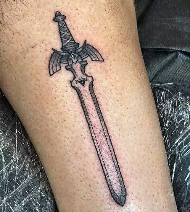 A tattoo of a sword on the leg.