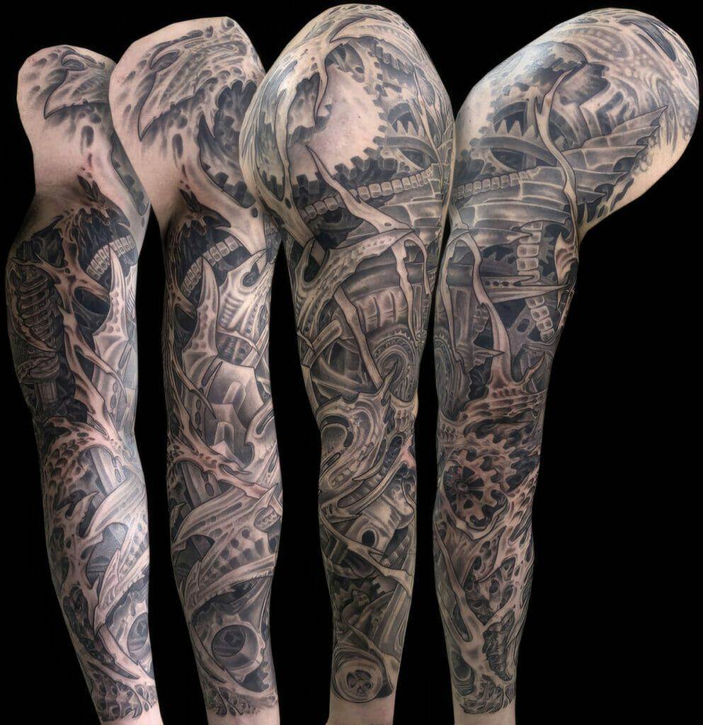 A sleeve with black and grey tattoos on it.