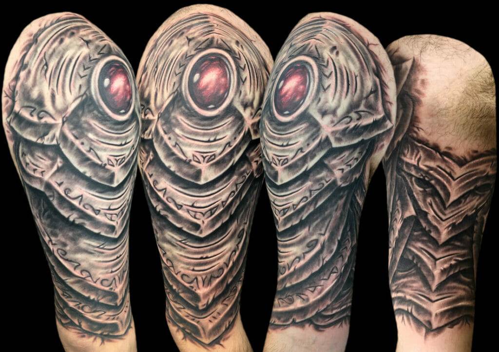 A sleeve tattoo of a skull with a red eye.