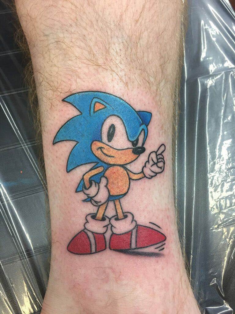 A sonic the hedgehog tattoo on a person's wrist.