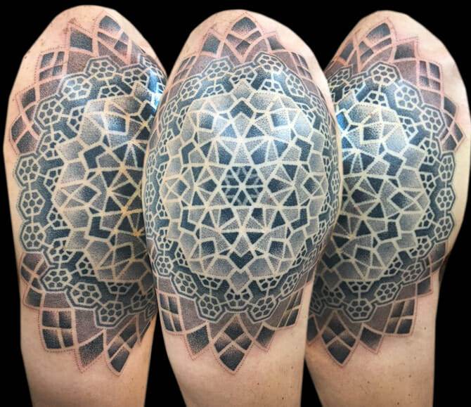 A man with a tattoo of a mandala on his sleeve.