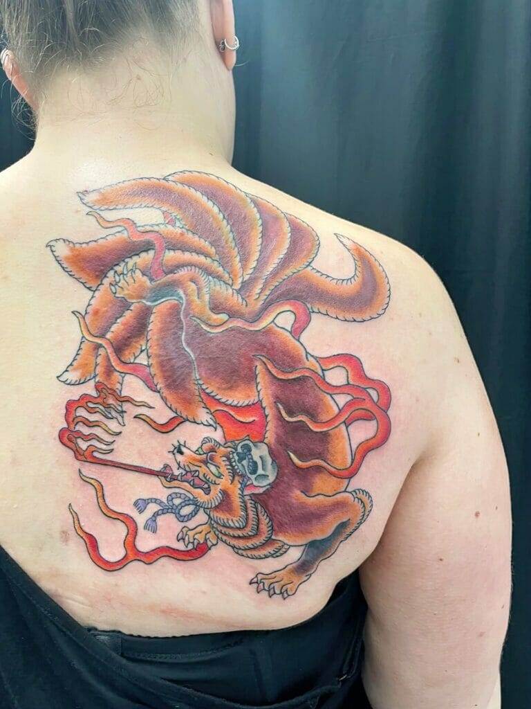 A woman with a dragon tattoo on her back.