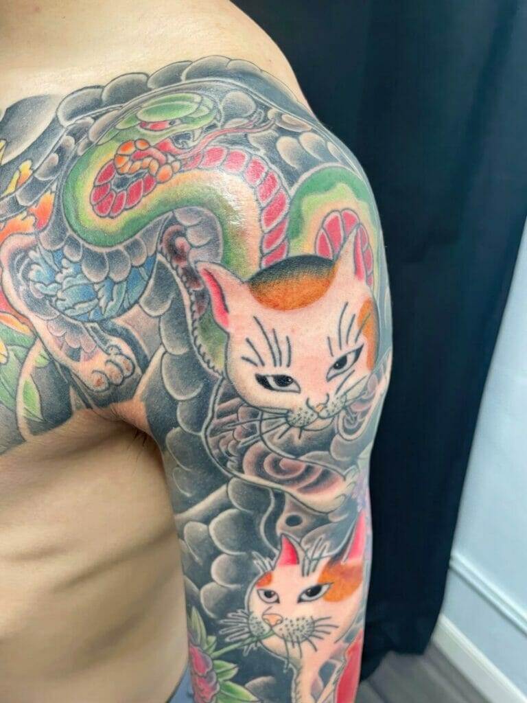 Japanese sleeve tattoo with cats and dragons.
