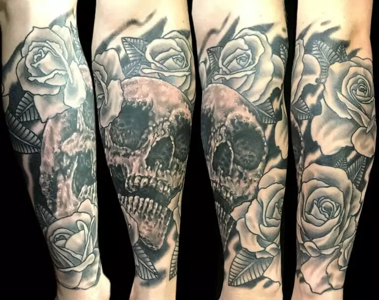 A tattoo of a skull and roses on a sleeve.