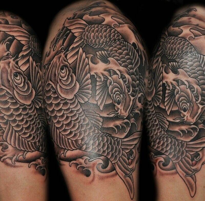 Black and gray koi fish tattoo on the sleeve.