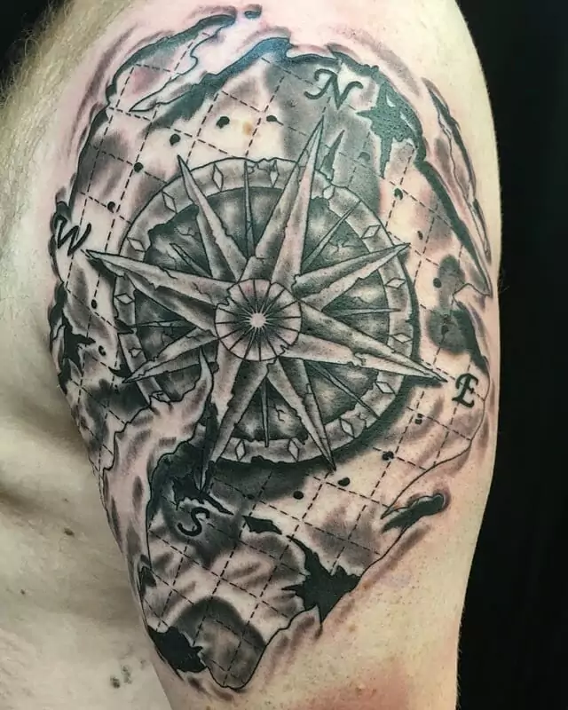 A compass tattoo on a man's shoulder.