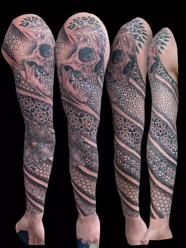 A sleeve of tattoos with a skull on it.